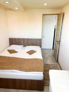 a bedroom with a large bed and a door at Lily`s Loft in Yerevan