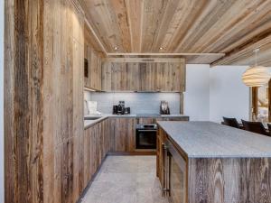 a kitchen with wooden cabinets and a counter top at Appartement Familial Confort à Val-d'Isère, Proche Pistes, 10 Pers., Cheminée, Services Inclus - FR-1-567-106 in Val dʼIsère +9 photos