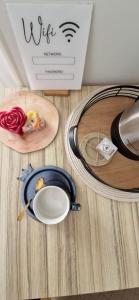 a table with a plate of food and a box at Mirko's home 2 Studio Apartment in Podgorica
