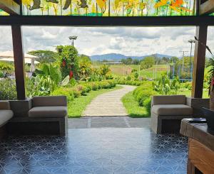 a patio with a stained glass window and a walkway at Hotel El Cielo en la Tierra in Quimbaya