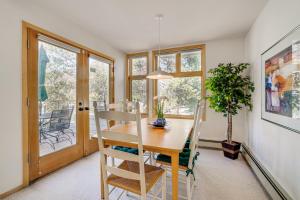 a dining room with a table and chairs and a plant at Mtn-View Deck, Workspace! Walkable Frisco Condo in Frisco