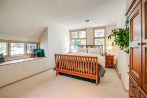 a bedroom with a bed and two windows at Mtn-View Deck, Workspace! Walkable Frisco Condo in Frisco