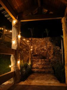 a stone wall with lights on it at night at Cedrito in Mineral del Chico