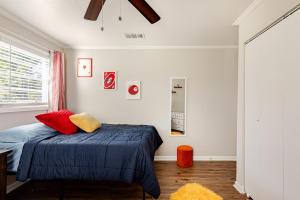 a bedroom with a bed with red and yellow pillows at Colorful & Cozy 3 Bedroom in Columbus in Columbus