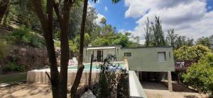 a house with a swimming pool in a forest at Vista Alago in Villa Ciudad Parque +39 photos