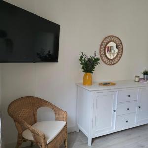 a room with a chair and a white dresser at La Casita de Mía in La Restinga