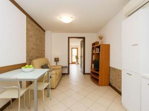 a kitchen and living room with a table and chairs at IL NIDO DI MASSIMO - a due passi dal centro città in Trieste
