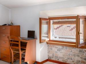 a room with a desk and a window with a laptop at IL NIDO DI MASSIMO - a due passi dal centro città in Trieste