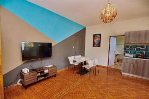 a living room with a table and a dining room at Villa SAIDIA climatisée avec PISCINE in Diego Suarez