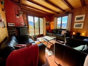 a living room with couches and a fireplace at Chalet Christina in Verbier