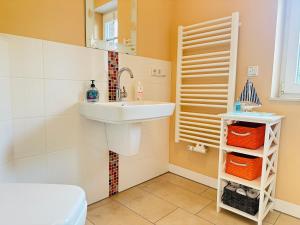 a bathroom with a sink and a toilet at Haus Abendsonne in Sankt Peter-Ording +28 photos