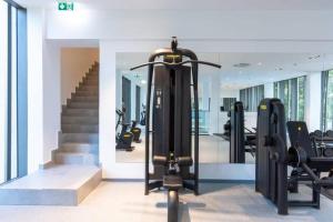 a gym with treadmills and exercise equipment in a building at The Lennox at Airport City, Accra in Accra