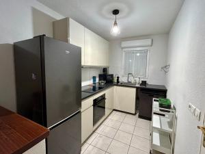 a kitchen with a stainless steel refrigerator in it at Le Patis in Poitiers