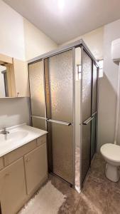 a bathroom with a shower with a sink and a toilet at Chalés Paraíso das Ilhas - Alto Cedros. in Rio dos Cedros +42 photos
