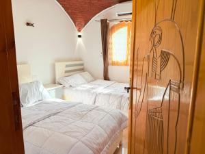 Ένα ή περισσότερα κρεβάτια σε δωμάτιο στο Upper Egypt Villa