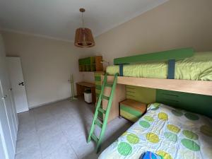 a bedroom with two bunk beds and a ladder at Casa divina in Yerba Buena