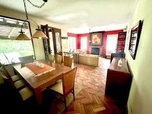 a dining room with a table and a kitchen at Casa divina in Yerba Buena +16 photos