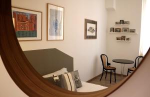 a mirror reflection of a room with a bed and a table at B&B Casa Trucchi in Ventimiglia