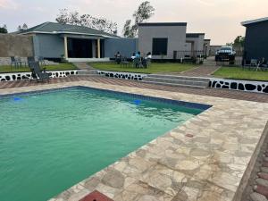 a pool of water in front of a house at Kings Nest Lodge in Chibotero