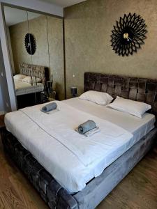 a bedroom with a large bed with two towels on it at BW Maša in Belgrade