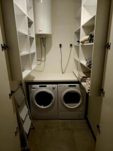a laundry room with a washer and dryer at BW Maša in Belgrade