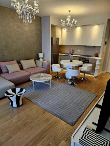 a living room with a couch and a table at BW Maša in Belgrade