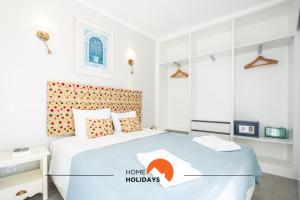 a bedroom with a bed with a home hollidays sign on it at #098 Casa Antonieta 3 by Home Holidays in Albufeira +47 photos
