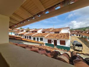 a view of a town from a building with roofs at Apartamento El trigal in Barichara