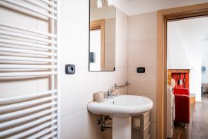 a white bathroom with a sink and a mirror at Narcê – Coastal Retreat in Porto Cesareo +19 photos