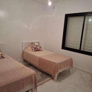 Postel nebo postele na pokoji v ubytování Villa Haute standing à coté plage Hassi jerbi