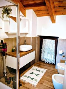 a bathroom with a sink and a toilet at La Mansarda Di Crevari in Crevari +30 photos