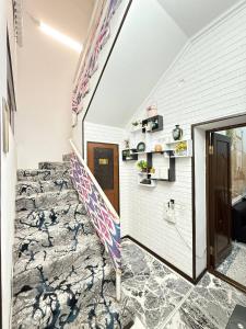 a staircase in a house with a mural on the wall at SumayShakh Guest House in Bukhara