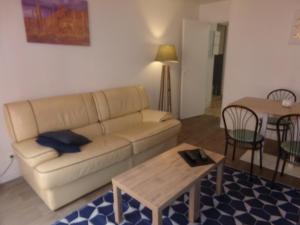 a living room with a couch and a table at La Belle Onde in Dieppe