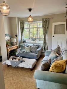 a living room with two couches and a table at 5 - Spacious Countryside House for Families & Groups in Pont Sticill