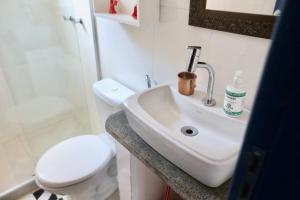 a bathroom with a white sink and a toilet at Casa Matatiso - casa de 2 quartos na Ilha Grande in Angra dos Reis
