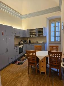 a kitchen with a table and chairs in a room at Wonderful apartment in the historic center in Bellinzona