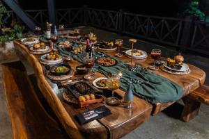 a table full of food on a wooden table at Hotel El Cielo en la Tierra in Quimbaya