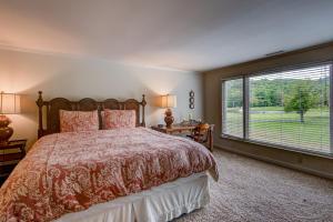 a bedroom with a bed and a large window at Lakes View at Hound Ears in Valle Crucis