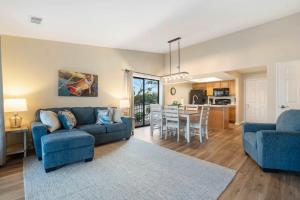 a living room with two blue couches and a kitchen at Lakeview At Table Rock in Kimberling City