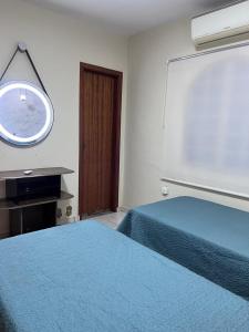 Ένα ή περισσότερα κρεβάτια σε δωμάτιο στο Conexão Executiva Prime