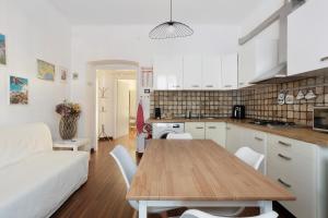 a kitchen and living room with a table and a couch at Maison18 in Pegazzano +15 photos