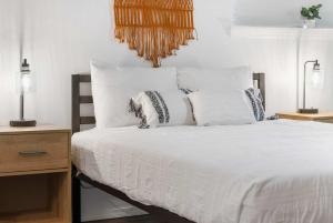 a bedroom with a bed with white sheets and pillows at Spring Creek Escape - Balcony with Views in Branson