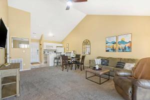 a living room with a couch and a table at Spring Creek Escape - Balcony with Views in Branson