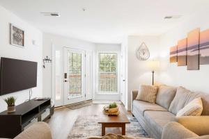 a living room with a couch and a tv at Boatin & Floatin on Table Rock Lake in the Ozarks in Kimberling City