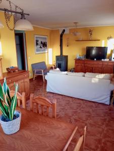a living room with a bed and a table and chairs at Chalet adosado entre playas in Argoños