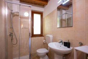 a bathroom with a toilet and a sink and a shower at Casa del Sol, Lozio Ospitar in Lozio +22 photos