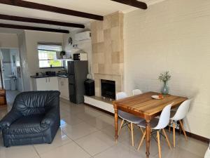 a kitchen and dining room with a table and chairs at Eagles Rest Guest House in Summerstrand