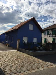 a blue house with a brick road in front of it at Gite Westhouse in Westhouse
