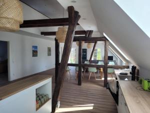 a staircase in a house with wooden beams at Heidehof Kuppendorf in Kirchdorf