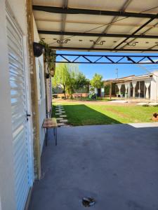 a patio with a bench on the side of a house at Hospedagem 1 studio & suites Patricia Tennis in Abelardo Luz +6 photos